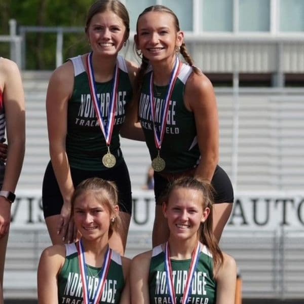 RFP athlete Annabeth standing on the podium with her 4x800 relay team