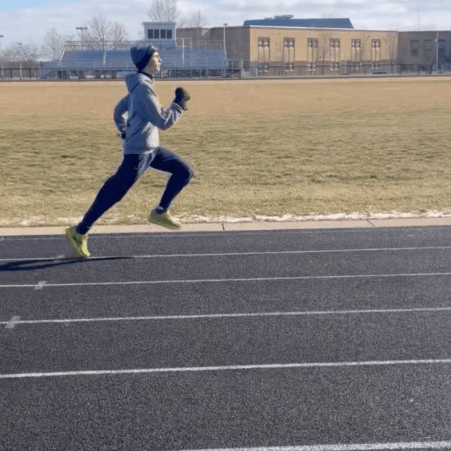 A middle school athlete running on an outdoor track in Lewis Center, Ohio during a running form assessment.